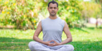 focused-young-indian-man-meditating-lotus-pose