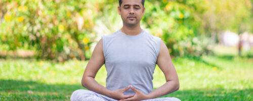 focused-young-indian-man-meditating-lotus-pose